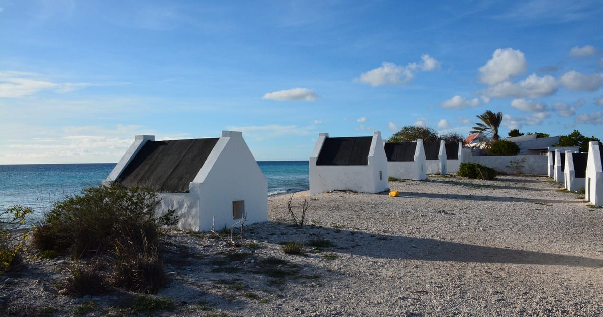 Row of restored stone slave huts beside the salt pans in southern Bonaire